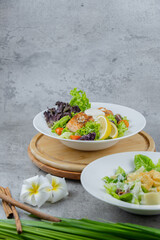 Healthy salmon salad with mixed greens, grilled salmon, cherry tomatoes, and lemon. A light and fresh dish perfect for healthy eating and food photography.