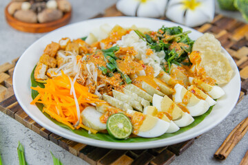 Traditional Indonesian salad made of boiled vegetables, tofu, eggs, and tempeh, served with rich peanut sauce. A flavorful and healthy plant-based dish.