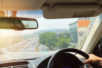 Image from inside of the car show traffic outdoor on suburb area of Bangkok, Thailand in the afternoon. Image use for transportation industry and holiday travel promotion background.
