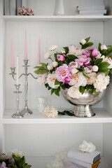 vase with white and pink flowers. candles in a candlestick. beautiful bouquet of soft small flowers...