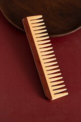 Natural wooden comb with wide teeth, perfect for gentle hair detangling and scalp massage. Ecology hair care and beauty routines