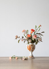 summer flowers in vintage ceramic vase on background white wall