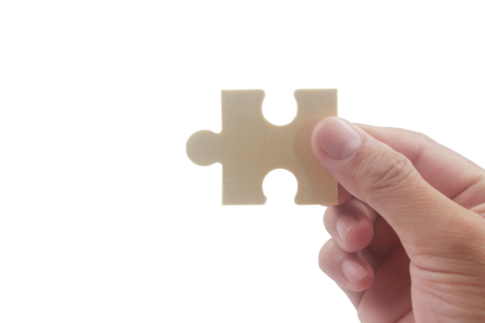 Puzzle piece placement creative workspace image minimalist background close-up problem solving concept