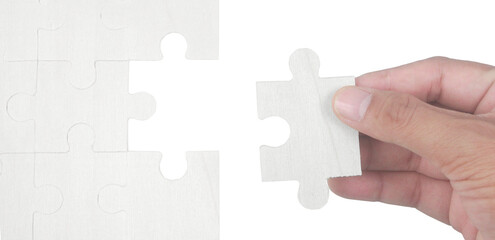 Placing final puzzle piece indoor table photo series minimalist environment close-up view puzzle concept