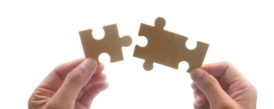 Collaboration and problem solving studio image bright close-up puzzle pieces fitting together