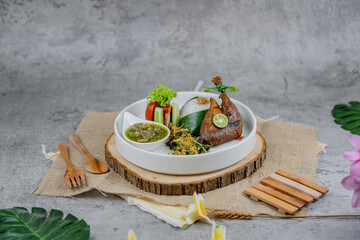 Crispy fried duck served with spicy sambal and grilled eggplant. A rich and bold Indonesian dish...
