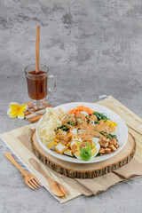 Traditional Indonesian salad made of boiled vegetables, tofu, eggs, and tempeh, served with rich peanut sauce. A flavorful and healthy plant-based dish.