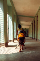 Fototapeta premium Children riding a bicycle down a long corridor