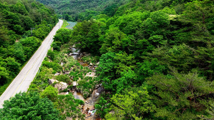 Aerial Drone Footage of a Clear Mountain Stream Flowing Through Mungyeong Countryside in Late Spring and Early Summer, Korea