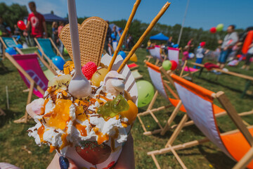 Close Up of Bubble Waffle with Ice Cream Whipped Cream and Jellies at Festival