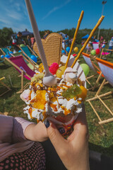 Close Up of Bubble Waffle with Ice Cream Whipped Cream and Jellies at Festival