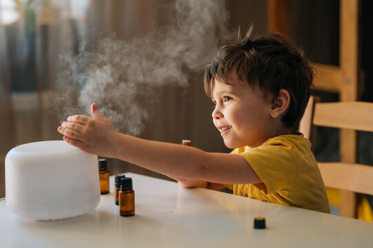 Child enjoying aromatherapy with a diffuser at home