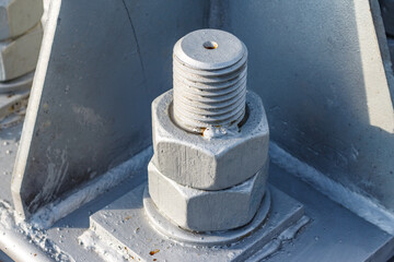 Heavy duty thick nuts screwed onto bolt thread
