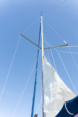 Fototapeta premium Sailboat mast reaching for the sky on a sunny day