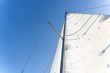 Fototapeta premium Sailboat mast reaching for the clear blue sky