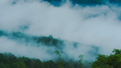 Aerial view of fog flowing over a mountain landscape in northern Thailand. Aerial view of beautiful mountains and clouds with fog.
