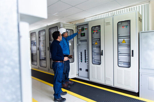 Engineers monitoring equipment in a substation control room