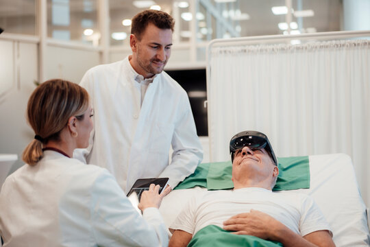 Doctor using virtual reality technology with patient in a medical office