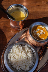Traditional Indian food and drink in copper vintage utensils