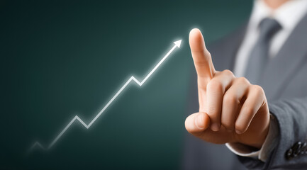 Business professional pointing at an upward financial graph, illustrating growth, rising profits, and strategic business advancement