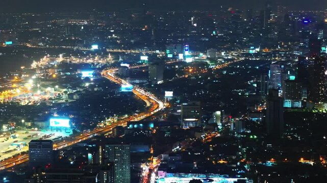 City lights illuminate the skyline showcasing vibrant urban life at night