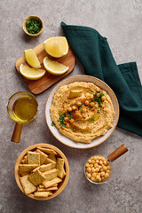 Delicious hummus with olive oil, chickpeas and parsley. Top view.