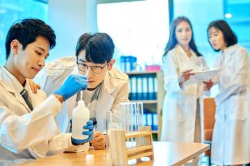 Young Asian Men and Women Scientists Collaborating in Modern Laboratory