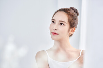 Young Asian Woman in White Tank Top with Elegant Updo, Minimalist Soft Light Portrait