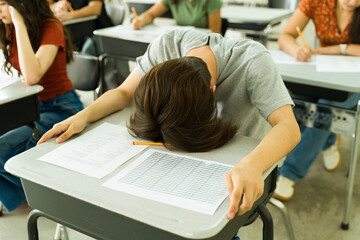Failing high school student feeling overwhelmed during exam