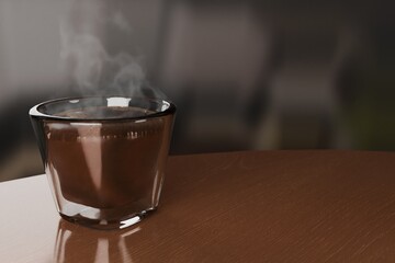 Steaming Hot Espresso Shot in Clear Thermic Glass on Wood