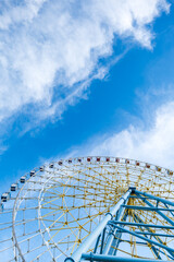 section of ferris wheel in the amusement park against blue sky with copy space for graphic design