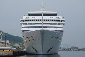 Ultra luxury all inclusive yacht cruiseship cruise ship liner Mariner docked at pier in Hakodate, Japan on Hokkaido island with city port harbor skyline panoramic scenic view