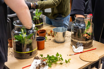 Creating a garden in a jar during art classes at gardening workshops