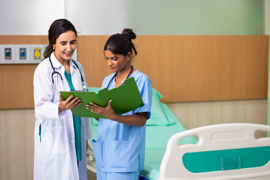 Woman Medical teamwork concept : Group of professional doctors meeting discussing diagnosis, checking test results in clinic. Medical staff, healthcare. Diverse people Asian Indian 