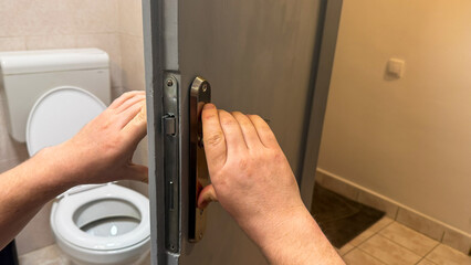 Two fair-skinned hands closing a restroom door, embody privacy zen, World Hand Hygiene Day,...