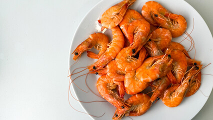 Boiled shrimp pile radiating fiery orange hues, embodying seaside brunches and unconventional Lunar New Year culinary celebrations