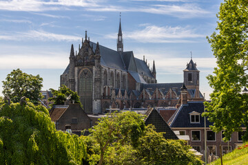 Majestic Hooglandse Kerk dominates the Leiden skyline, its Gothic architecture rising above lush...