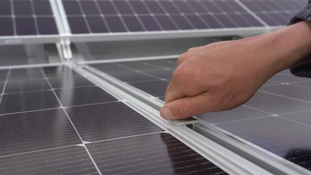Fixing solar panels to the frame.