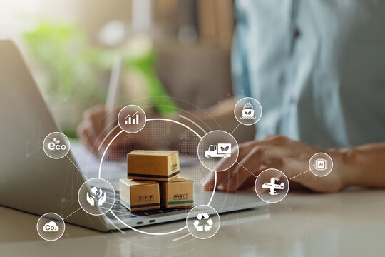 Green logistics or Sustainable global transport.Sustainable logistics businessman planning with parcel and eco packaging on Desk.Transport Management System technology for clean energy eco friendly. - Powered by Adobe