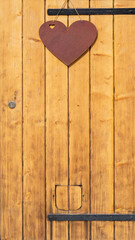 rustic wooden wwod barn door, with steel hinges and heart symbol for decoration