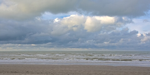 North sea beach with dark stomy clouds in De Panne, Flanders, Belgium 