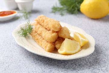 Tasty tempura shrimps, lemon and dill on grey textured table, closeup
