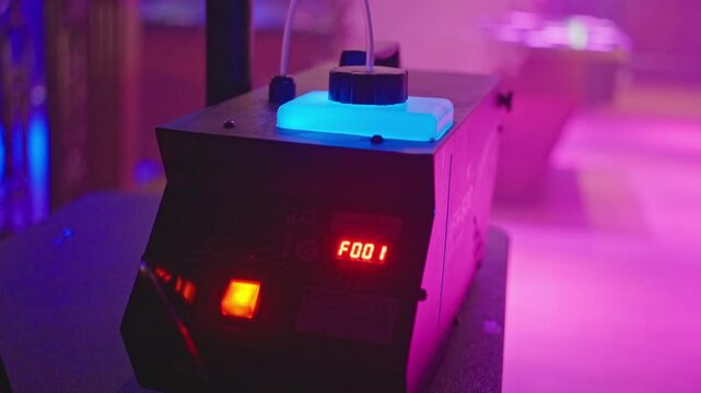 A modern fog machine creates a stunning atmosphere in a vibrant, energetic club