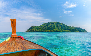 Turquoise clear water and traditional wooden boat in Bamboo island, Phi Phi, Thailand