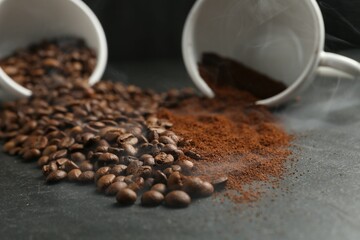 Aromatic ground coffee and beans on black table, closeup