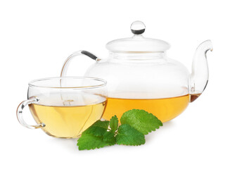 Aromatic lemon balm tea in glass cup, teapot and fresh leaves isolated on white