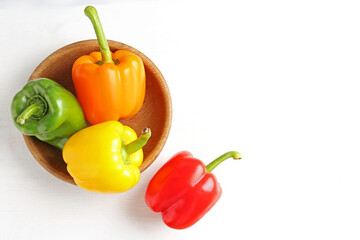 Ripe colorful bell peppers on white table, flat lay. Space for text