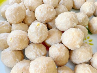 Close-up of traditional Indonesian snack made from cassava or tapioca flour, shaped into round balls, typically used as meatball substitute or fried snack.