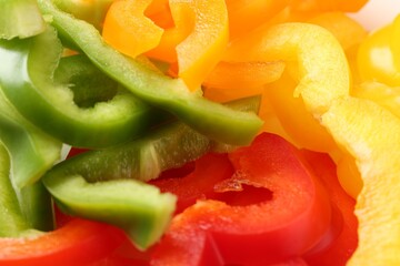 Slices of fresh colorful bell peppers as background, closeup