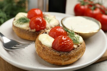 Tasty stuffed mushrooms served on table, closeup
